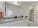 Bathroom with double vanity, framed mirror, and shower/tub combo with curtain at 15120 Downham Dr, Fishers, IN 46037