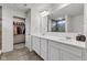 Double vanity bathroom with quartz countertop and access to walk-in closet at 15120 Downham Dr, Fishers, IN 46037