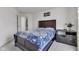 Bedroom with a bed with blue patterned bedspread and a dark wood headboard and bedside table at 15120 Downham Dr, Fishers, IN 46037