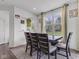 Cozy dining area with a modern table, chairs, and a large window overlooking the backyard. Plenty of natural light at 15120 Downham Dr, Fishers, IN 46037