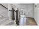 Inviting home entryway with hardwood floors, staircase, and views into the open living area. Natural light pouring in from windows at 15120 Downham Dr, Fishers, IN 46037