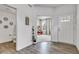 Inviting foyer with hardwood floors leading to a bright living area and features a view of the downstairs half-bathroom at 15120 Downham Dr, Fishers, IN 46037