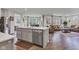 Open concept gourmet kitchen island with quartz countertop and stainless steel appliances, connecting to the living room at 15120 Downham Dr, Fishers, IN 46037