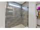 Modern walk-in shower with glass door and horizontally laid tile at 15120 Downham Dr, Fishers, IN 46037