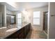Bathroom features a double vanity with granite countertop, tile flooring, and a glass-enclosed shower at 16204 Oakford Trl, Fishers, IN 46037