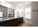 Bathroom featuring a double vanity with granite countertop, framed mirrors and a glass-enclosed shower at 16204 Oakford Trl, Fishers, IN 46037