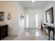 Bright foyer with tile floors, a front door with sidelights, and neutral decor at 16204 Oakford Trl, Fishers, IN 46037