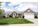 Charming brick home with manicured lawn, lush landscaping, and a two-car garage at 16204 Oakford Trl, Fishers, IN 46037