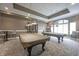 Inviting game room featuring billiard tables, stylish lighting, and comfortable seating for entertainment at 16204 Oakford Trl, Fishers, IN 46037
