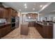 Modern kitchen with granite countertops, stainless steel appliances, and an island, seamlessly connected to the living space at 16204 Oakford Trl, Fishers, IN 46037