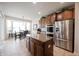 Bright kitchen with granite countertops, stainless steel appliances, and an island, with a view of the dining area at 16204 Oakford Trl, Fishers, IN 46037