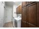Bright laundry room featuring a washer, dryer, storage cabinets, and tiled floor at 16204 Oakford Trl, Fishers, IN 46037