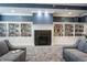 Cozy library with floor-to-ceiling bookshelves, a fireplace, and comfortable seating for reading and relaxation at 16204 Oakford Trl, Fishers, IN 46037