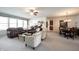 Spacious living room featuring plush seating, ceiling fan, and an open layout to the kitchen and dining area at 16204 Oakford Trl, Fishers, IN 46037