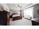 Serene main bedroom featuring neutral colors, a tray ceiling, and a comfortable sitting area at 16204 Oakford Trl, Fishers, IN 46037