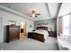 Spacious main bedroom featuring a tray ceiling, neutral colors, and a comfortable sitting area at 16204 Oakford Trl, Fishers, IN 46037