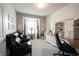 Well-lit office space with built-in desk, bay window, comfortable seating, and neutral carpet at 16204 Oakford Trl, Fishers, IN 46037