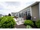 Covered patio with neutral-colored seating and meticulously manicured landscaping with a built in grill at 16204 Oakford Trl, Fishers, IN 46037
