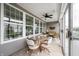 Bright sunroom with a ceiling fan, tiled floors, furniture, and multiple windows at 16204 Oakford Trl, Fishers, IN 46037