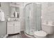 This bathroom features a modern glass shower, a vanity with a mirror, and a toilet at 1641 N Cornell Ave, Indianapolis, IN 46202