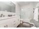 This modern bathroom showcases a double vanity, sleek fixtures, and a shower-tub combination with elegant tiling at 1641 N Cornell Ave, Indianapolis, IN 46202