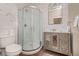 Well-lit bathroom with a glass-enclosed shower, modern vanity, and stylish fixtures at 1641 N Cornell Ave, Indianapolis, IN 46202
