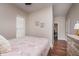 Relaxing bedroom showcasing warm tones, wood floors, and natural light from window at 1641 N Cornell Ave, Indianapolis, IN 46202