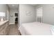 A cozy bedroom featuring light gray walls, wood-style flooring, and a glimpse into a walk-in closet at 1641 N Cornell Ave, Indianapolis, IN 46202