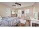 Cozy bedroom with a ceiling fan, hardwood floors, natural light, and tasteful decor at 1641 N Cornell Ave, Indianapolis, IN 46202