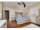 Comfortable bedroom with a ceiling fan, hardwood floors, a desk, and tasteful decor at 1641 N Cornell Ave, Indianapolis, IN 46202