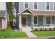 Home exterior featuring manicured lawn, walkway, and charming front porch with classic architectural details at 1641 N Cornell Ave, Indianapolis, IN 46202