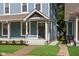 A view of a blue duplex with inviting steps and landscaping with green grass at 1641 N Cornell Ave, Indianapolis, IN 46202
