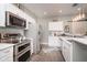 Modern kitchen with stainless steel appliances, white cabinets, and a tile backsplash for a clean design at 1641 N Cornell Ave, Indianapolis, IN 46202