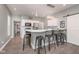 Stylish kitchen boasting white cabinets, stainless steel appliances, and a breakfast bar with seating for four at 1641 N Cornell Ave, Indianapolis, IN 46202