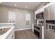 Modern kitchen with stainless steel appliances, quartz countertops, and bright windows for great natural light at 1641 N Cornell Ave, Indianapolis, IN 46202