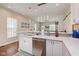 Bright kitchen featuring white cabinets, stainless steel appliances, and elegant pendant lighting at 1641 N Cornell Ave, Indianapolis, IN 46202
