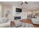 Inviting living room features modern fireplace, ceiling fan, and hardwood floors, adjacent to kitchen bar at 1641 N Cornell Ave, Indianapolis, IN 46202