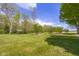 Spacious backyard with meticulously maintained lawn and mature trees at 1840 W 100 N, Columbus, IN 47201