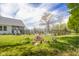 Backyard fire pit with seating, overlooking in-ground pool, and mature trees at 1840 W 100 N, Columbus, IN 47201
