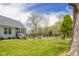 The backyard features a well-maintained lawn, a fence, and a playset, offering a great space for outdoor activities at 1840 W 100 N, Columbus, IN 47201
