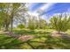 Green backyard with mature trees, perfect for relaxing and enjoying the outdoors at 1840 W 100 N, Columbus, IN 47201