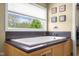 Lovely bathroom features a soaking tub and window at 1840 W 100 N, Columbus, IN 47201