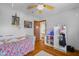 A well-lit room featuring a ceiling fan, hardwood floors, and cozy decor at 1840 W 100 N, Columbus, IN 47201