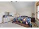 Well-lit bedroom with vaulted ceiling, quilt bedspread, and traditional style dresser at 1840 W 100 N, Columbus, IN 47201