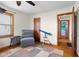 A naturally lit bedroom with wood trim, cozy seating, and classic desk area at 1840 W 100 N, Columbus, IN 47201
