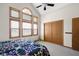 Bright bedroom with vaulted ceiling, large windows, and a traditional style closet at 1840 W 100 N, Columbus, IN 47201