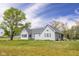 Charming single-Gathering home featuring a lush green lawn and mature trees providing shade and beauty at 1840 W 100 N, Columbus, IN 47201
