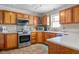 Updated kitchen with stainless steel appliances, stylish wood cabinets, and durable granite countertops at 1840 W 100 N, Columbus, IN 47201