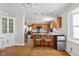 Bright and spacious kitchen features warm wood cabinets, stainless steel appliances, and hardwood floors at 1840 W 100 N, Columbus, IN 47201