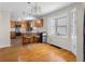Open kitchen with hardwood floors, island seating, and stainless steel appliances, ideal for entertaining at 1840 W 100 N, Columbus, IN 47201